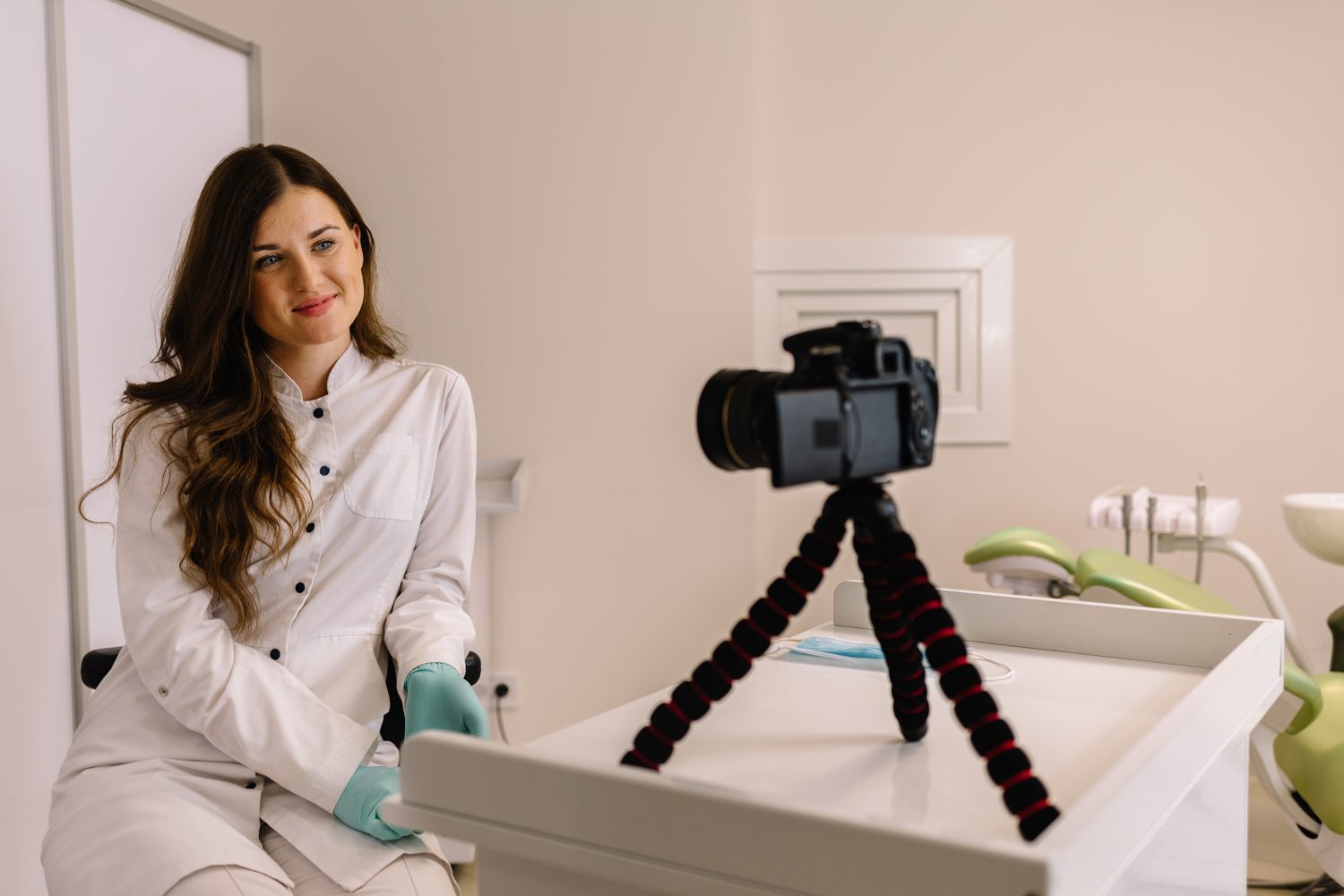 Young female doctor dentist recording video for his blog