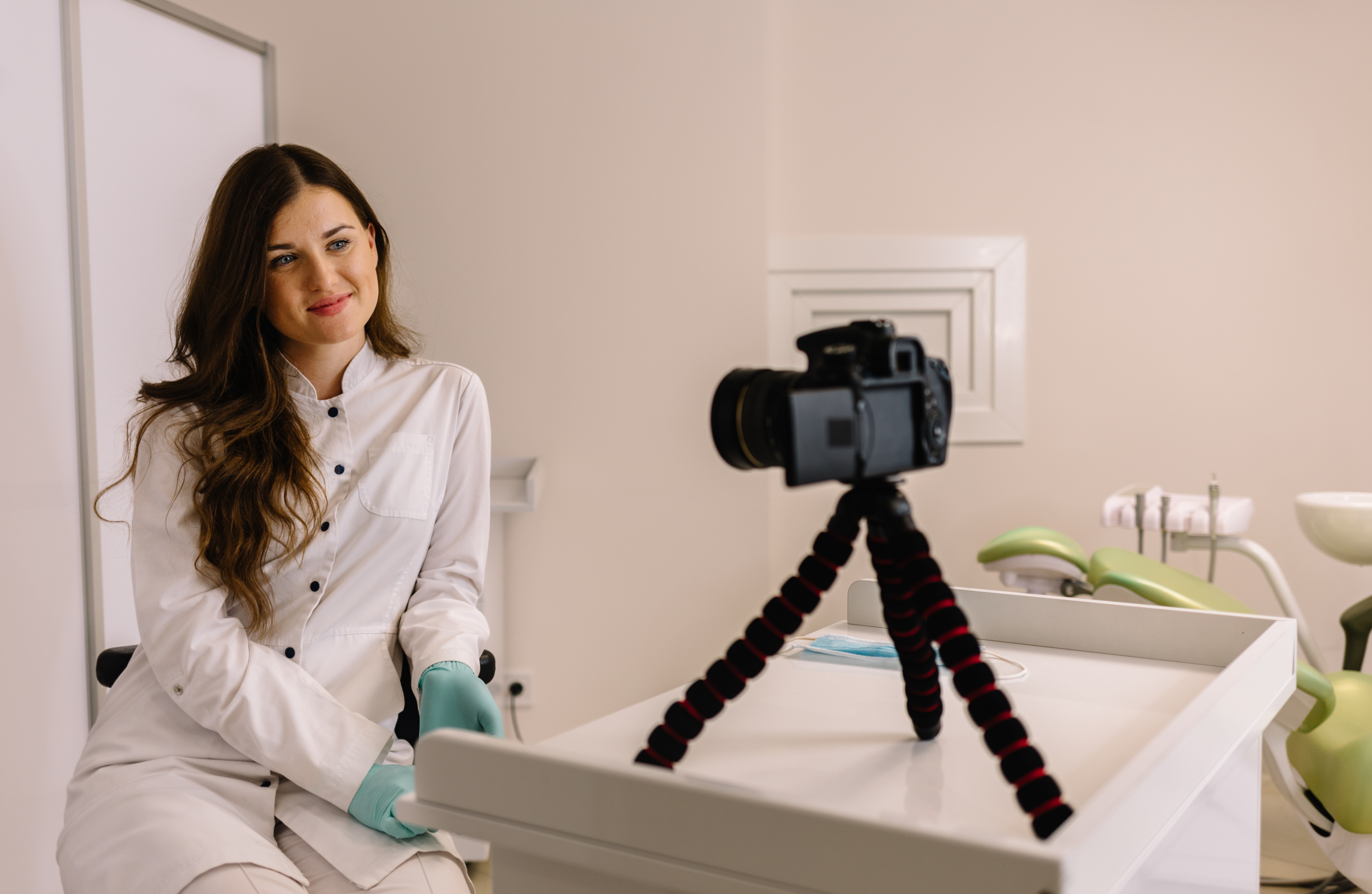 Young female doctor dentist recording video for his blog